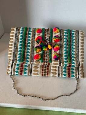 Charade Boho Embroidered Woven Clutch with Pom Poms and Chain Strap.